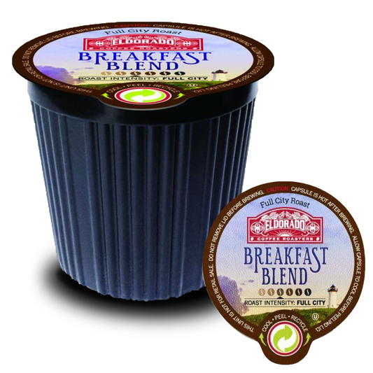 A single-serve El Dorado Coffee Roasters Breakfast Blend coffee pod rests on its foil lid.  The pod is black with a green recycling symbol and "Full City Roast" printed on the top.