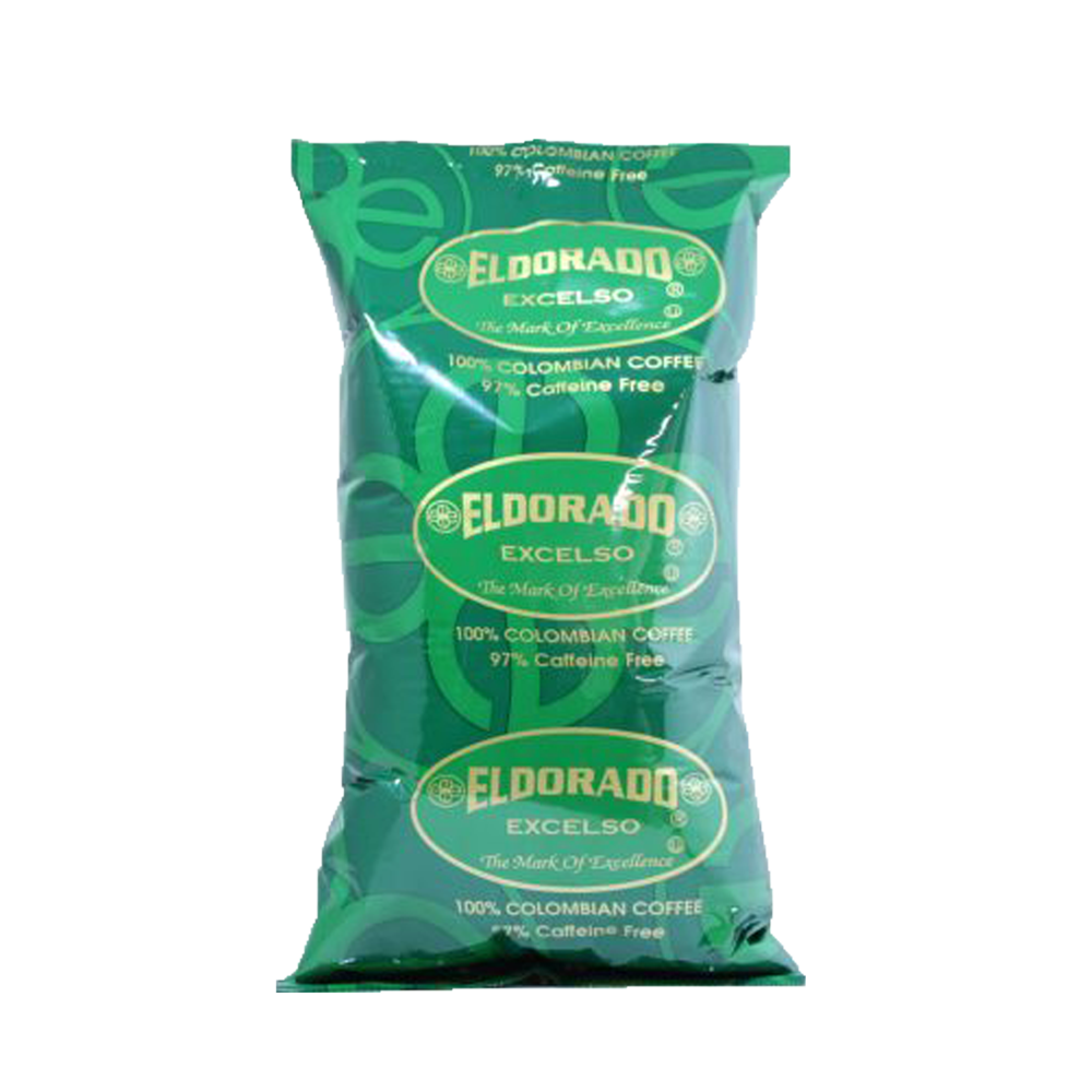 A green foil bag of Eldorado Excelso 97% Caffeine Free coffee, showcasing its Colombian origin and "The Mark of Excellence" slogan.