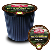 A black single-serve coffee pod filled with Eldorado Coffee Roasters Colombian Popayan Supremo coffee sits on a white background with a peeled foil lid beside it. 
