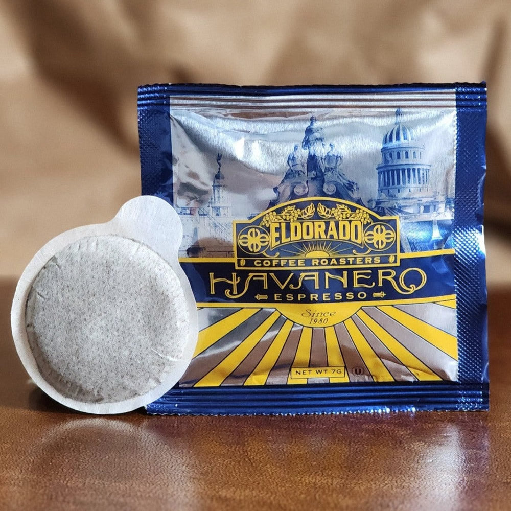 An El Dorado Coffee Roasters "Havanero Espresso" single-serve coffee pod rests in front of its foil packaging. 
