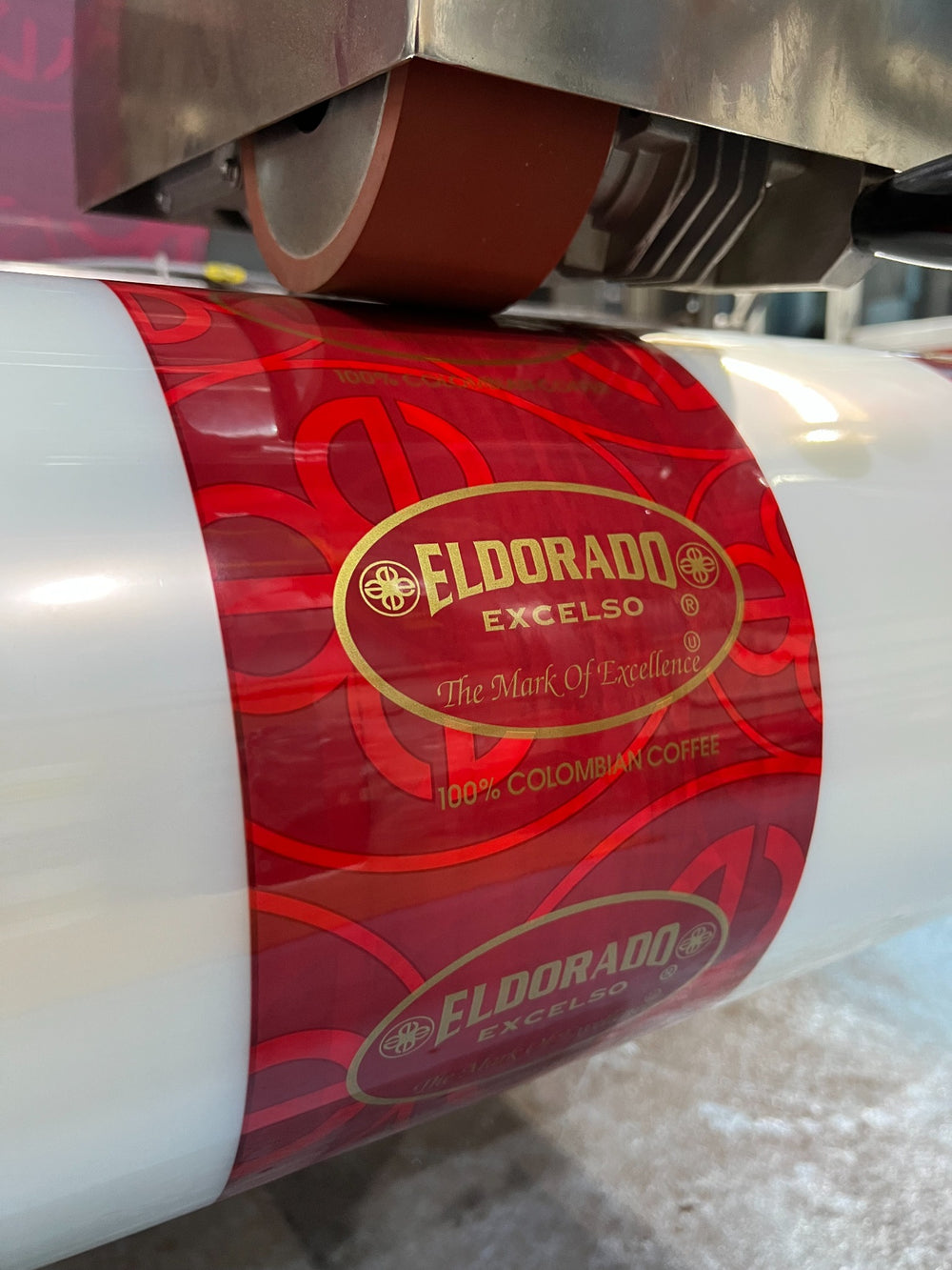 Printed coffee packaging film running through production equipment