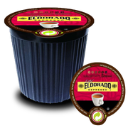A single-serve Cafe Eldorado espresso capsule sits on its lid, showcasing the dark roast intensity and promising a rich coffee experience. 
