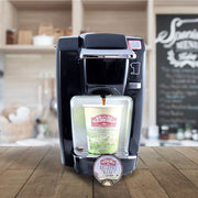 Black Keurig K-Cup coffee maker brewing a cup of Eldorado Breakfast Blend coffee into a to-go cup. 
